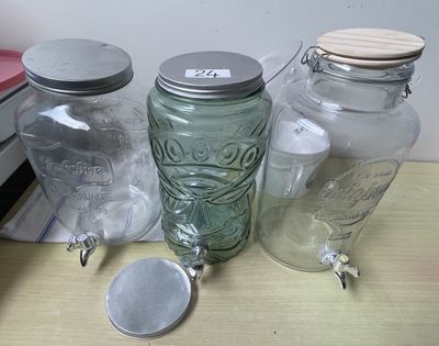 three glass jars with lids on a table