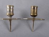 pair of antique brass candlesticks on a stand on a white background