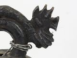 a black and gold vase with a dragon head on it