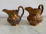 two vases that are sitting on a table