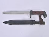 a knife and a knife holder on a white surface