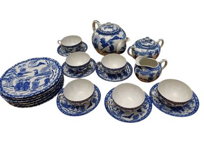 a blue and white tea set on a white table