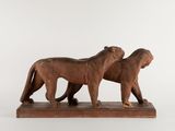 pair of carved wood lions on a marble base