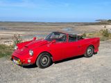 a red car that is parked on the side of the road