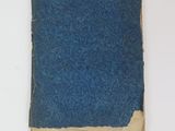 a piece of blue paper on a white surface