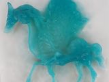 a blue plastic horse that is sitting on a white surface
