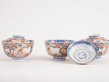 three small blue and white bowls with designs on them on a white surface