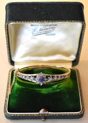 an image of a diamond and sapphire bangle in a box