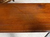 a wooden table with a wooden top on a tile floor