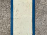 an image of a blue picture frame on a concrete wall