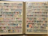 an open book with stamps on it sitting on a table