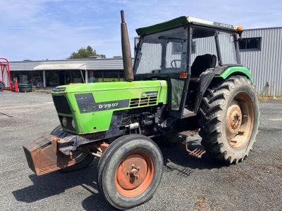 a green tractor that is parked in the parking lot
