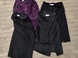 two pairs of black and purple pants on a wooden floor