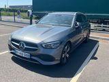 the mercedes cla is parked in the parking lot next to the road