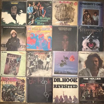 a bunch of records are stacked on top of each other on a table
