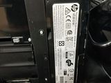 a close up of a black printer with a white label on it