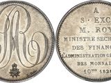 a close up of a coin with a monogram on it