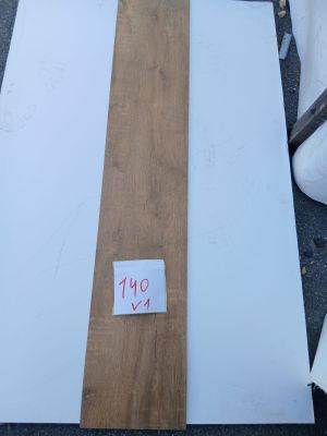 some pieces of wood sitting on top of a table next to a pile of bags
