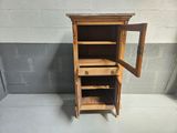a small wooden cabinet with a mirror on top of it