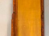 a wooden shelf with a mirror hanging on the wall
