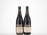 two bottles of wine sitting on top of a table next to each other