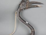 une vieille paire de pinces posée sur une surface grise, avec une corde