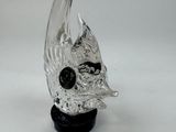 a glass sculpture of a bird with a skull on it ' s head