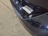 a close up of a car ' s front bumper with a tag on it