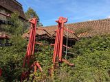 a red machine that is sitting in the grass
