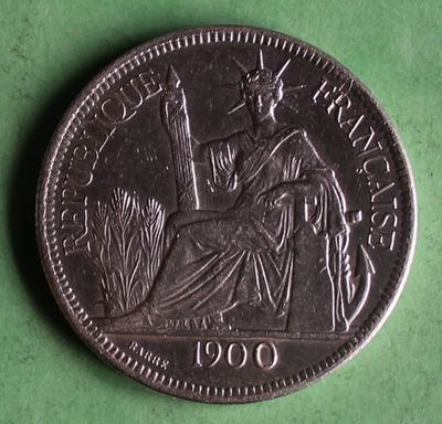 a close up of a coin on a green surface