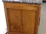 a wooden cabinet with a granite top in a living room