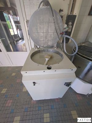 a machine that is sitting on the floor next to a mixer