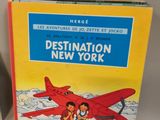 a book with a picture of two children standing in front of an airplane