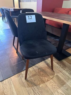 une chaise noire placée devant une table dans une pièce