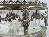 a silver plate with a glass decanter on it