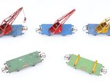 four different types of toy trains on a white surface