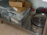 many boxes and pans sitting on a stainless steel table