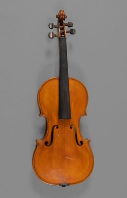 an old violin with a bow hanging on a wall