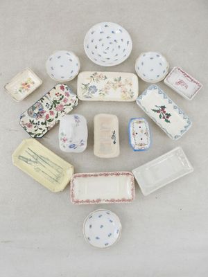 many different types of plates and bowls on the table