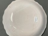 a white plate on a table with a tag on it