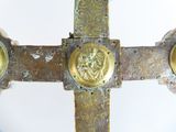 a cross made of metal with gold decorations on it