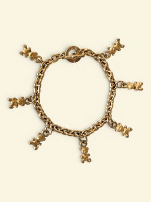 an image of a gold bracelet with charms on a white background
