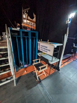 a stage set up for a movie with a chair and a sign