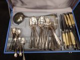 a blue box with silverware in it on a table