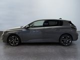 a grey car is parked in a room with a white wall
