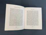 an open book on a table with a black background