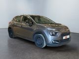 the grey car is parked in a white room with a black floor