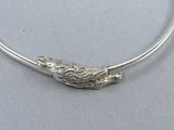 sterling silver bang bracelet with a twisted design on the end of it
