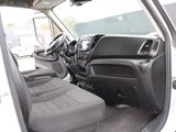 the interior of a white van with the door open and the driver ' s seat down