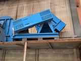 a blue machine that is sitting on top of a building